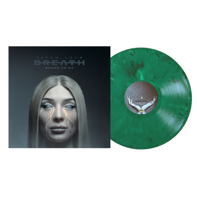 A green marbled opaque vinyl record by Catch Your Breath rests beside its 12 album cover, showing a long-haired blonde woman with glowing eyes and denim-clad legs. The limited edition cover reads “Catch Your Breath – Shame On Me.”.